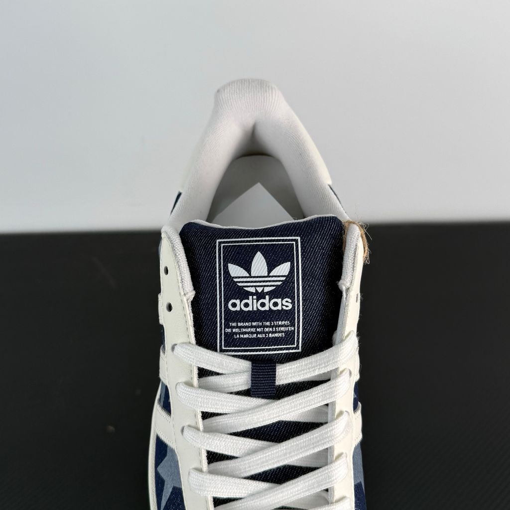 Side profile of the adidas Superstar II 'Denim Star' sneaker, showcasing the textured denim-style upper, classic serrated Three-Stripes branding, and the signature white rubber shell toe.