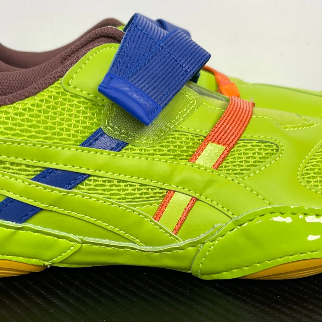 Side profile of the ASICS x Issey Miyake Hyper Taping sneaker in a sophisticated green tonal colorway, highlighting the unique, ribbon-like taping construction, sleek silhouette, and premium collaborative detailing.