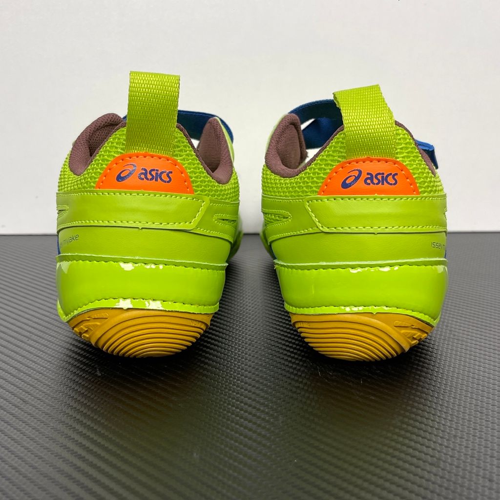 Side profile of the ASICS x Issey Miyake Hyper Taping sneaker in a sophisticated green tonal colorway, highlighting the unique, ribbon-like taping construction, sleek silhouette, and premium collaborative detailing.