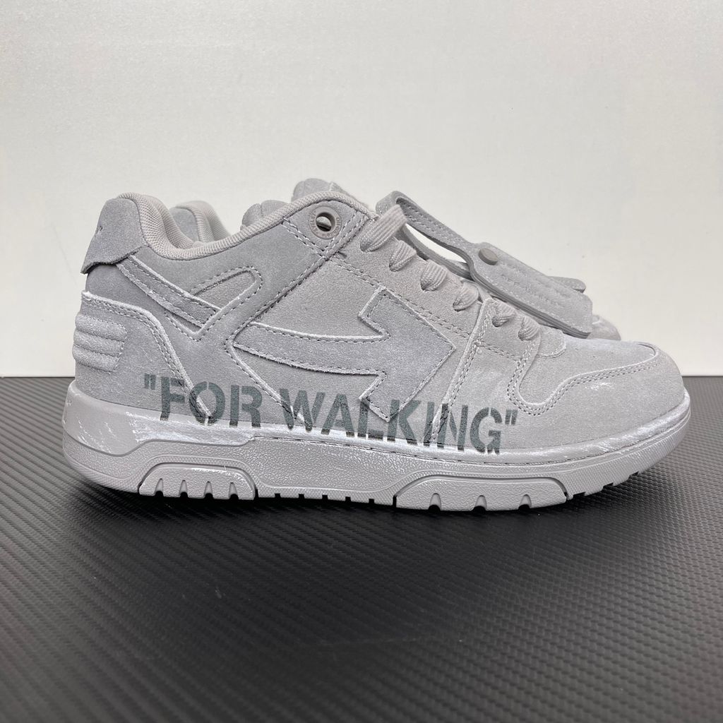 Side profile of the Off-White Out of Office sneaker in a Distressed Dark Grey colorway, highlighting the iconic "FOR WALKING" text printed on the midsole, signature arrow motif, and premium weathered suede construction.
