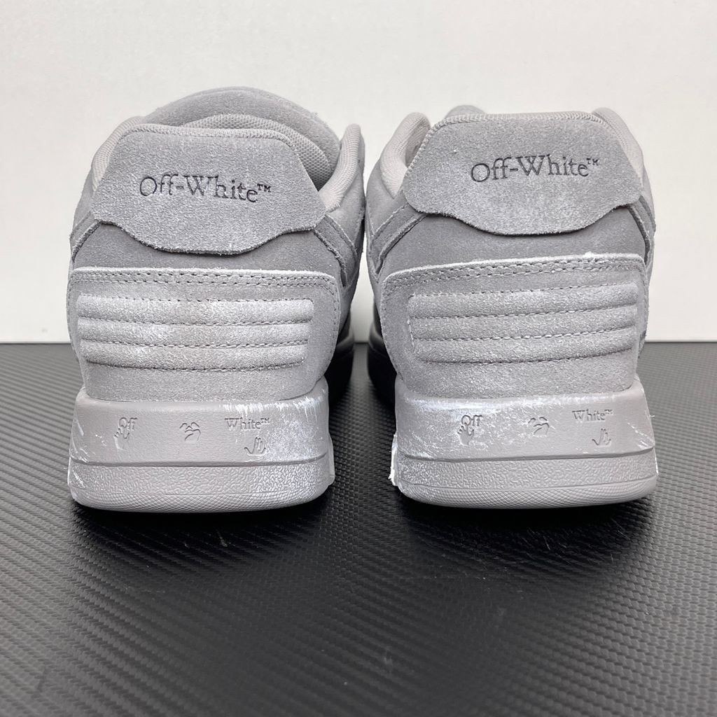 Side profile of the Off-White Out of Office sneaker in a Distressed Dark Grey colorway, highlighting the iconic "FOR WALKING" text printed on the midsole, signature arrow motif, and premium weathered suede construction.