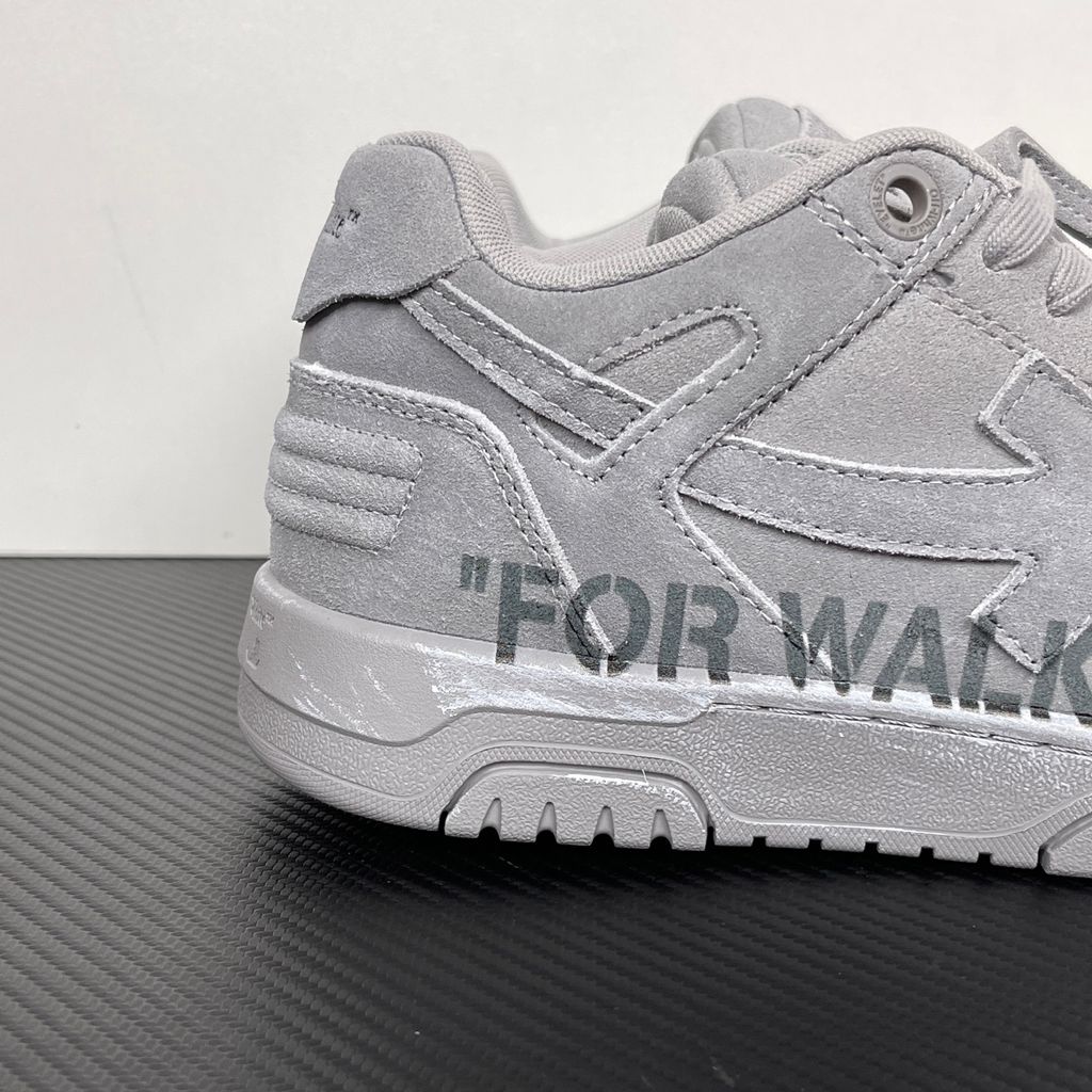 Side profile of the Off-White Out of Office sneaker in a Distressed Dark Grey colorway, highlighting the iconic "FOR WALKING" text printed on the midsole, signature arrow motif, and premium weathered suede construction.