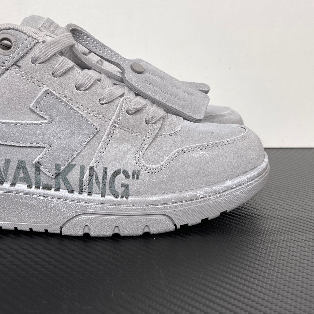 Side profile of the Off-White Out of Office sneaker in a Distressed Dark Grey colorway, highlighting the iconic "FOR WALKING" text printed on the midsole, signature arrow motif, and premium weathered suede construction.