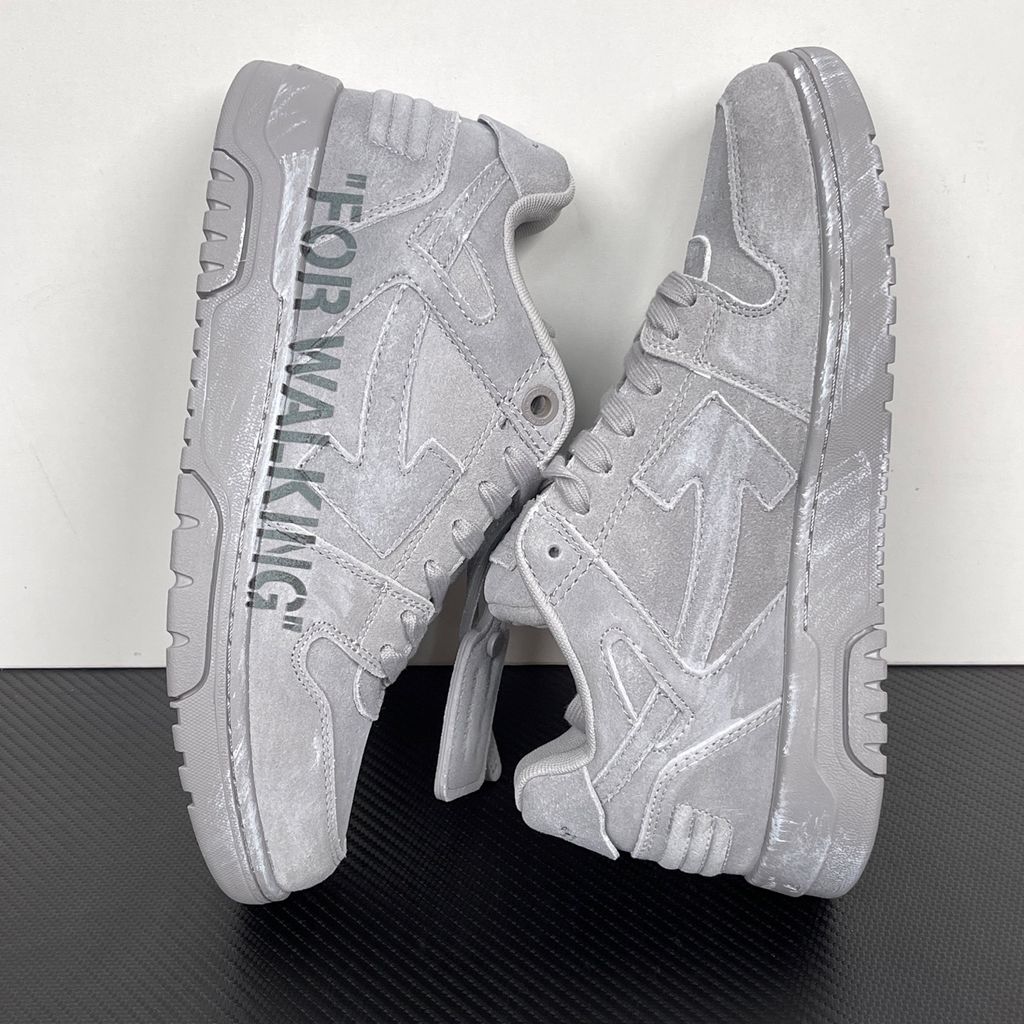 Side profile of the Off-White Out of Office sneaker in a Distressed Dark Grey colorway, highlighting the iconic "FOR WALKING" text printed on the midsole, signature arrow motif, and premium weathered suede construction.