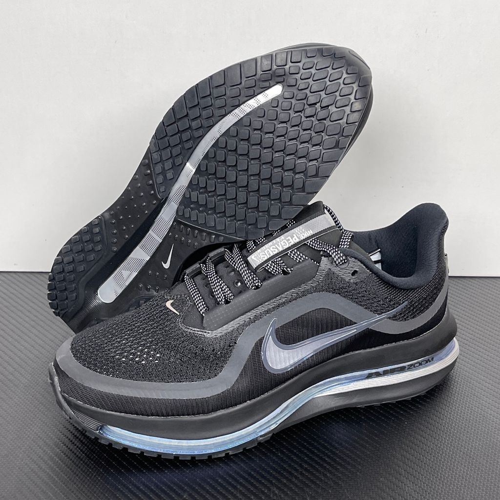 Side profile of the Nike Air Zoom Pegasus Premium sneaker in the 'Black Metallic Silver' colorway, showcasing the lightweight black engineered mesh upper, shimmering metallic silver Swoosh branding, and the sculpted, responsive midsole.