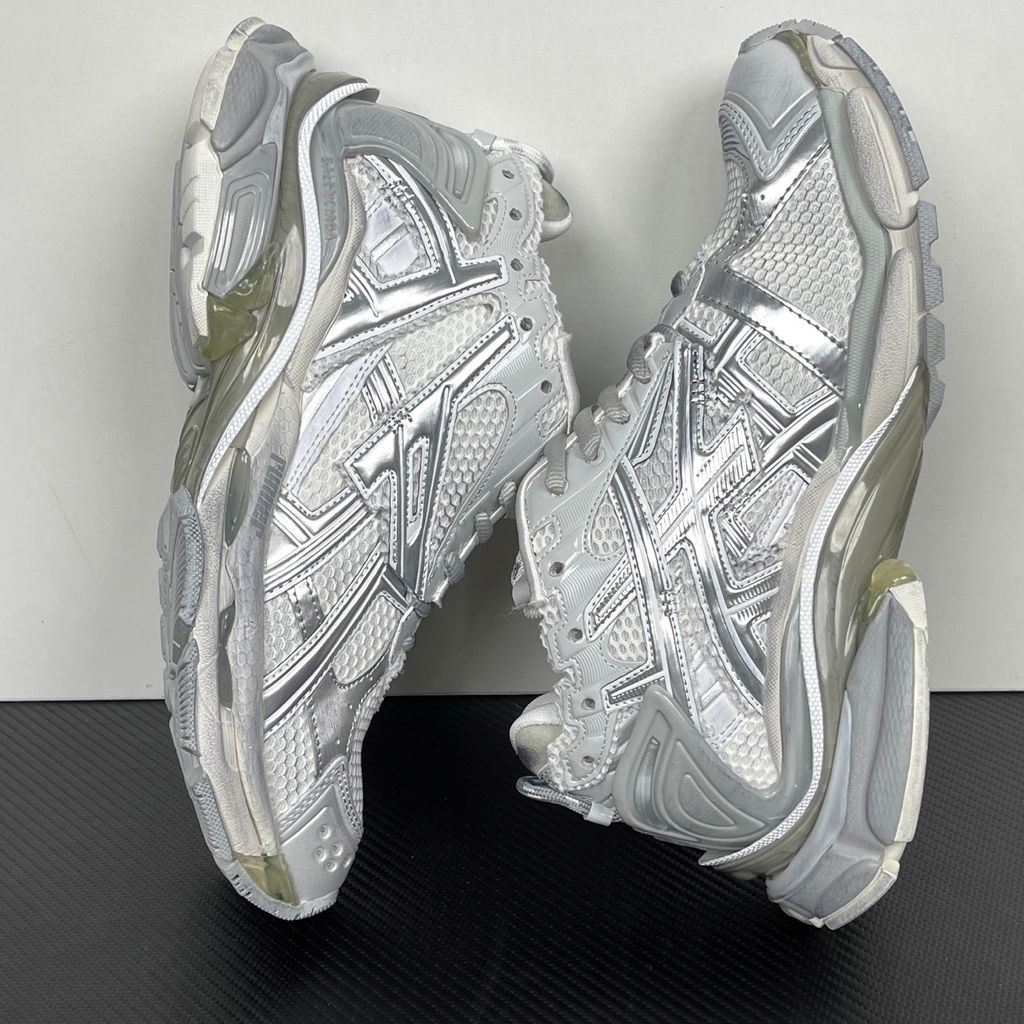 Side profile of the Balenciaga Runner sneaker in the 'White Silver' colorway, highlighting the complex multi-layered construction, distressed technical mesh and synthetic overlays, and the iconic dynamic sole unit.