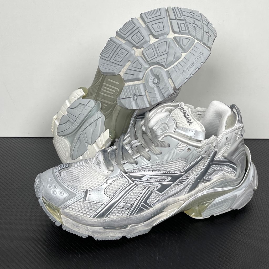 Side profile of the Balenciaga Runner sneaker in the 'White Silver' colorway, highlighting the complex multi-layered construction, distressed technical mesh and synthetic overlays, and the iconic dynamic sole unit.