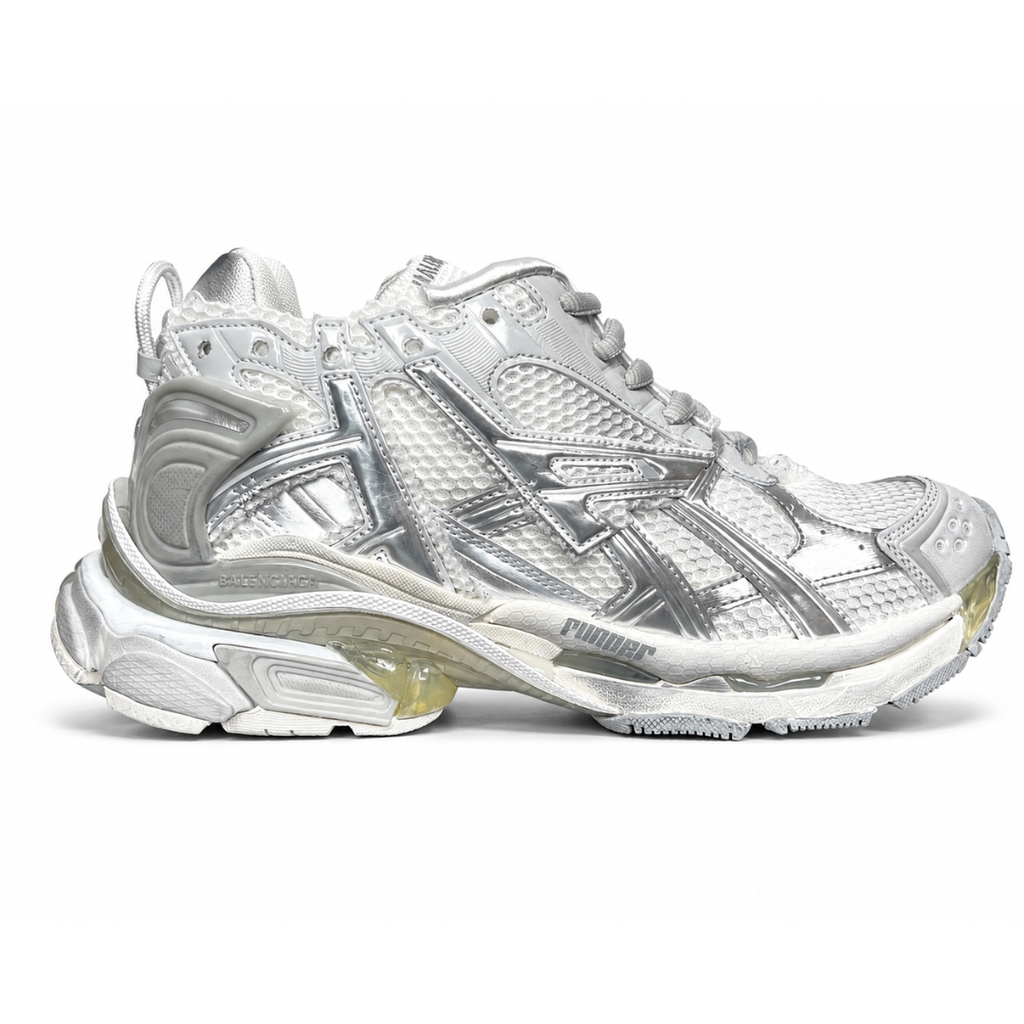 Side profile of the Balenciaga Runner sneaker in the 'White Silver' colorway, highlighting the complex multi-layered construction, distressed technical mesh and synthetic overlays, and the iconic dynamic sole unit.
