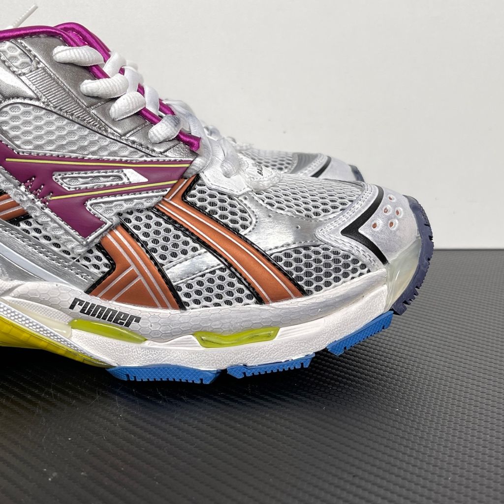 Side profile of the Balenciaga Runner sneaker in the 'Multicolor' colorway, highlighting the intricate multi-layered construction, distressed technical mesh and synthetic overlays, and the iconic dynamic sole unit.