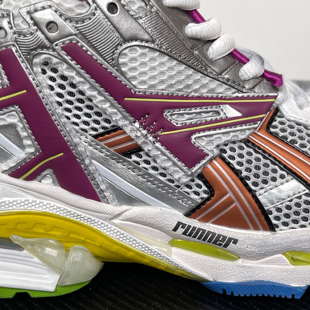 Side profile of the Balenciaga Runner sneaker in the 'Multicolor' colorway, highlighting the intricate multi-layered construction, distressed technical mesh and synthetic overlays, and the iconic dynamic sole unit.