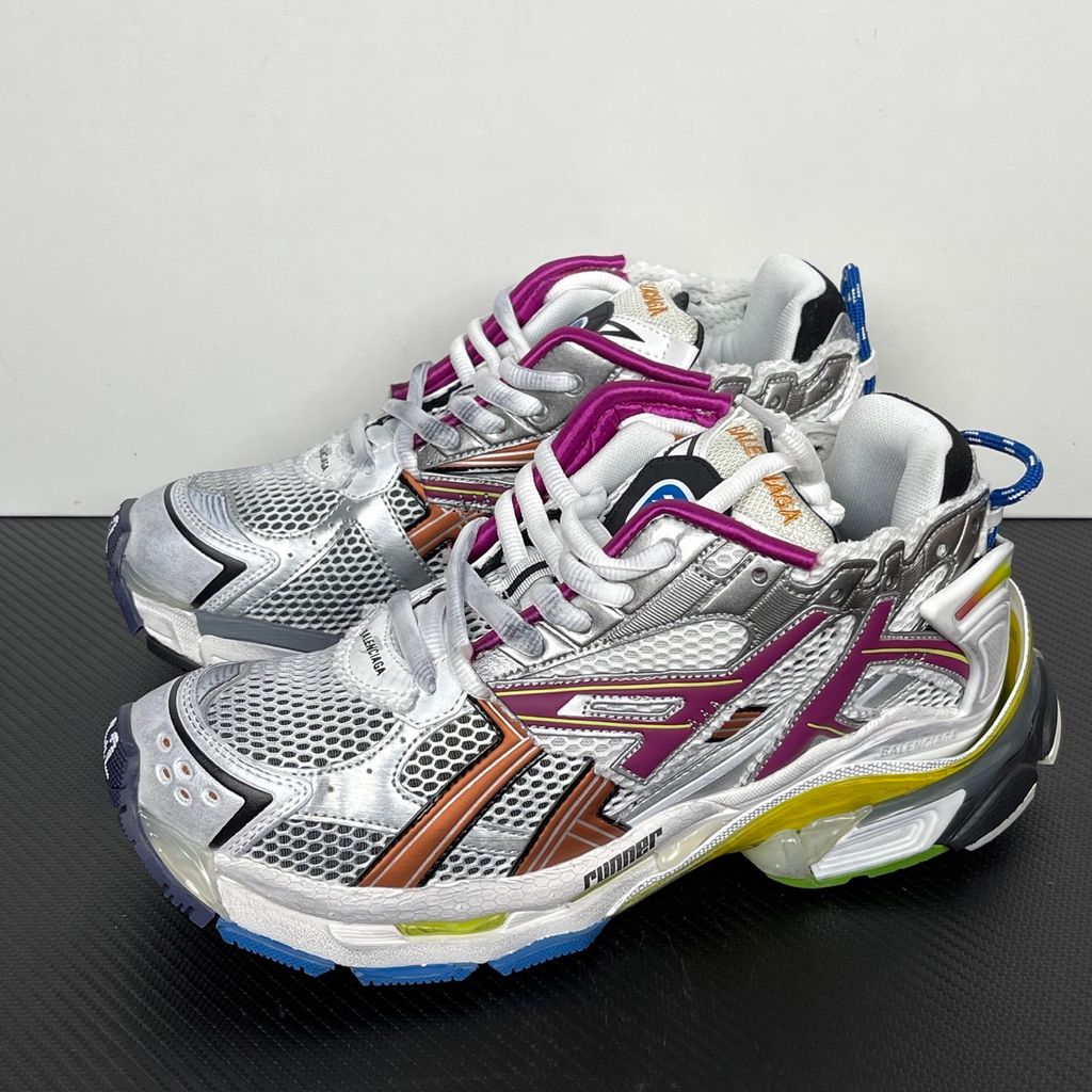 Side profile of the Balenciaga Runner sneaker in the 'Multicolor' colorway, highlighting the intricate multi-layered construction, distressed technical mesh and synthetic overlays, and the iconic dynamic sole unit.