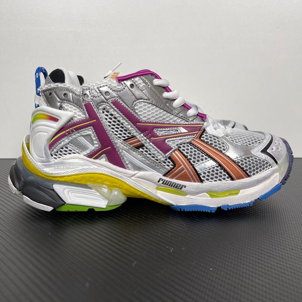 Side profile of the Balenciaga Runner sneaker in the 'Multicolor' colorway, highlighting the intricate multi-layered construction, distressed technical mesh and synthetic overlays, and the iconic dynamic sole unit.