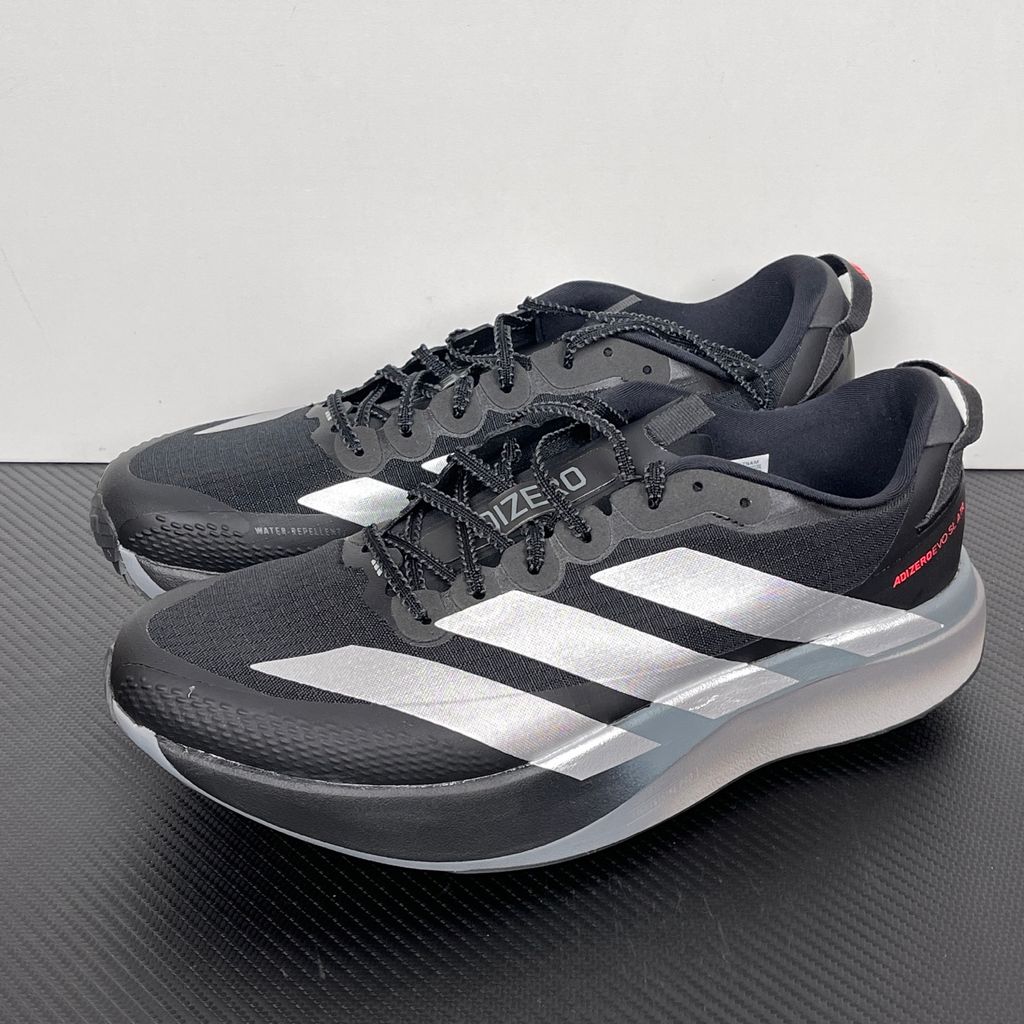 Side profile of the adidas Adizero Evo SL running shoe in the 'ATROnix Grey Black' colorway, showcasing the ultra-lightweight breathable mesh upper, sleek aerodynamic profile, and the sculpted Lightstrike Pro foam midsole.
