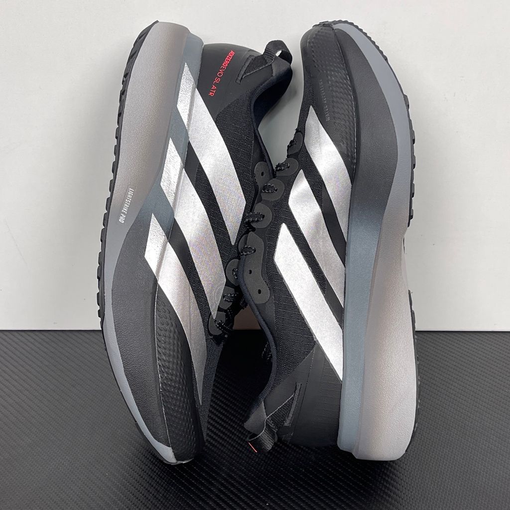Side profile of the adidas Adizero Evo SL running shoe in the 'ATROnix Grey Black' colorway, showcasing the ultra-lightweight breathable mesh upper, sleek aerodynamic profile, and the sculpted Lightstrike Pro foam midsole.