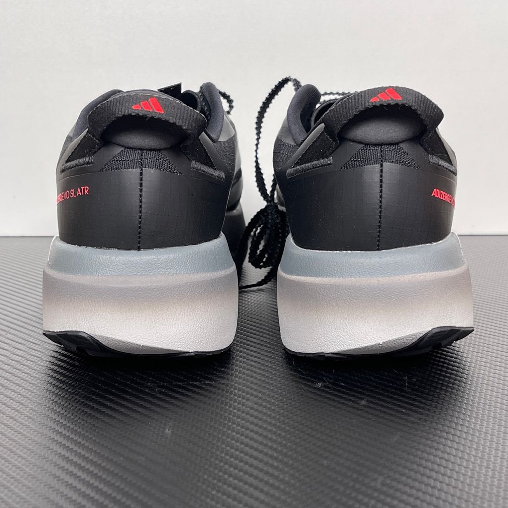 Side profile of the adidas Adizero Evo SL running shoe in the 'ATROnix Grey Black' colorway, showcasing the ultra-lightweight breathable mesh upper, sleek aerodynamic profile, and the sculpted Lightstrike Pro foam midsole.