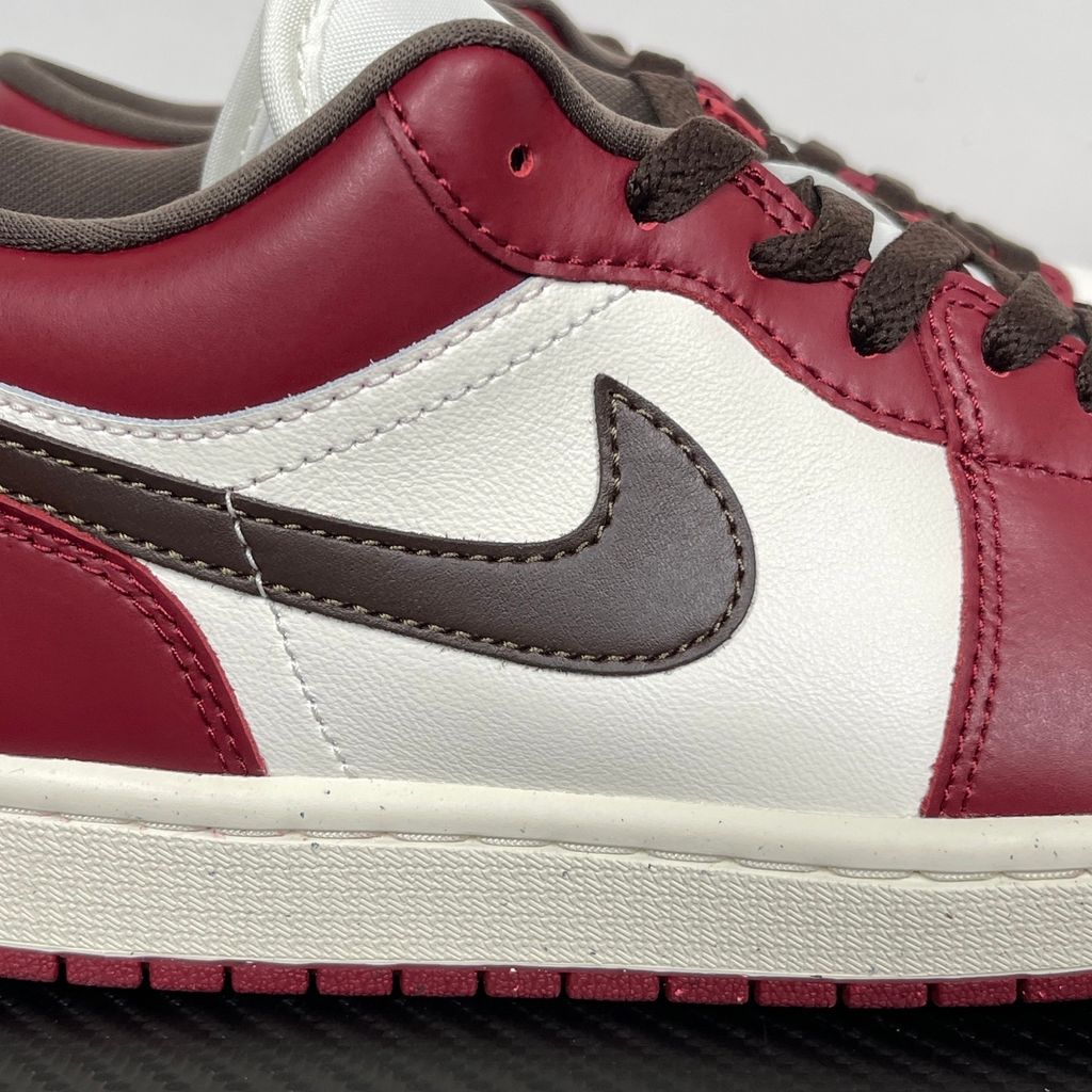 Side profile of the Air Jordan 1 Low SE sneaker in the 'Sail Baroque Brown Team Red' colorway, showcasing the smooth sail leather base, rich baroque brown overlays, and striking team red Swoosh.