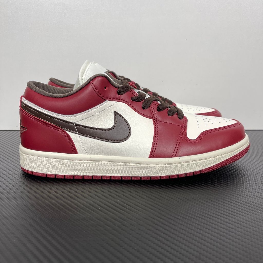 Side profile of the Air Jordan 1 Low SE sneaker in the 'Sail Baroque Brown Team Red' colorway, showcasing the smooth sail leather base, rich baroque brown overlays, and striking team red Swoosh.