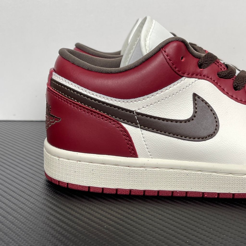 Side profile of the Air Jordan 1 Low SE sneaker in the 'Sail Baroque Brown Team Red' colorway, showcasing the smooth sail leather base, rich baroque brown overlays, and striking team red Swoosh.