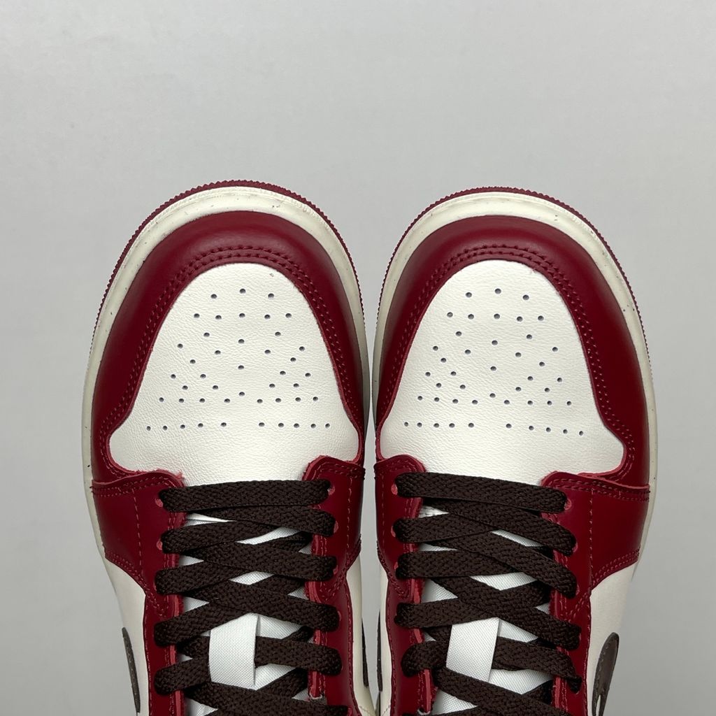 Side profile of the Air Jordan 1 Low SE sneaker in the 'Sail Baroque Brown Team Red' colorway, showcasing the smooth sail leather base, rich baroque brown overlays, and striking team red Swoosh.