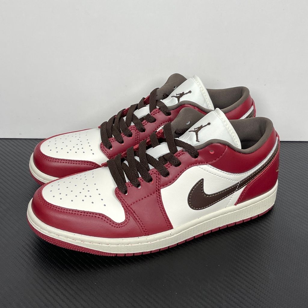Side profile of the Air Jordan 1 Low SE sneaker in the 'Sail Baroque Brown Team Red' colorway, showcasing the smooth sail leather base, rich baroque brown overlays, and striking team red Swoosh.