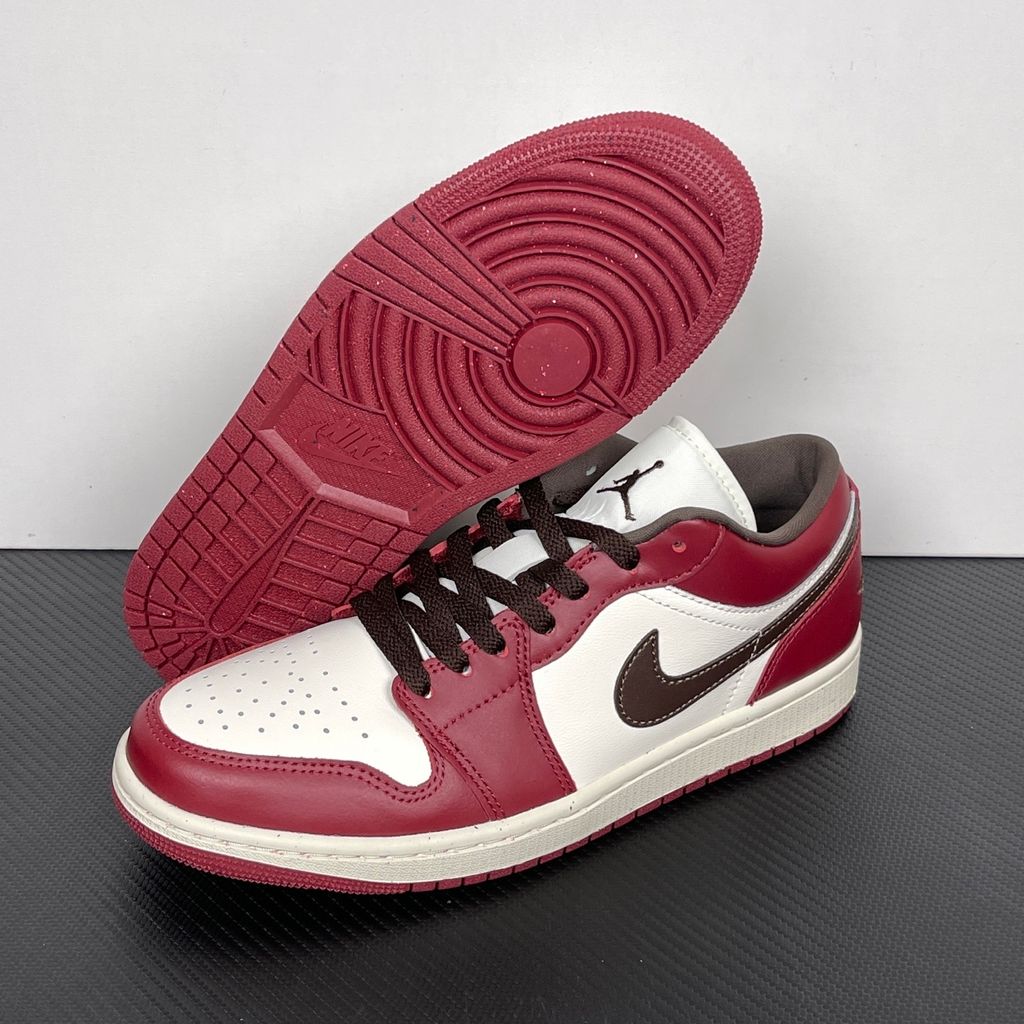 Side profile of the Air Jordan 1 Low SE sneaker in the 'Sail Baroque Brown Team Red' colorway, showcasing the smooth sail leather base, rich baroque brown overlays, and striking team red Swoosh.
