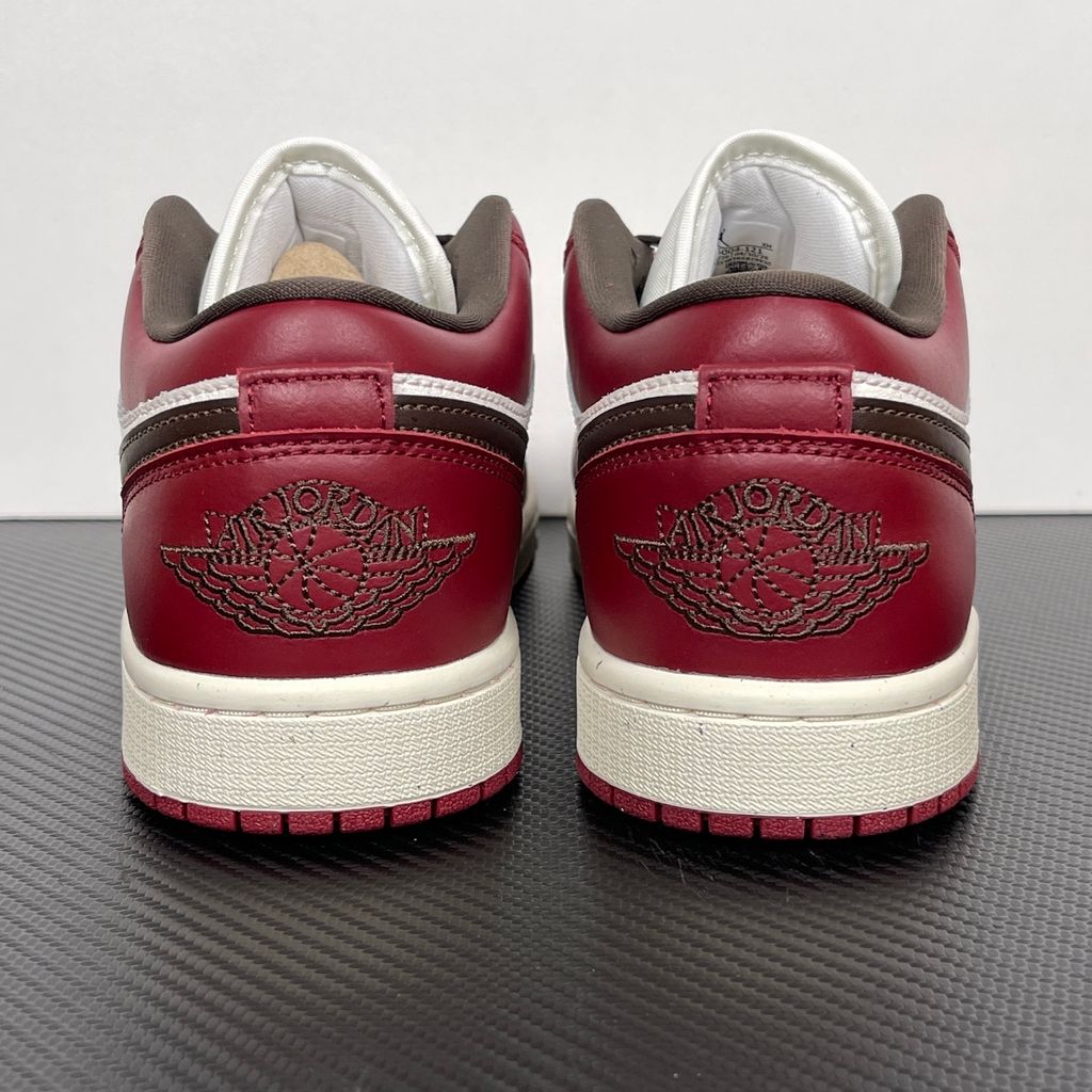 Side profile of the Air Jordan 1 Low SE sneaker in the 'Sail Baroque Brown Team Red' colorway, showcasing the smooth sail leather base, rich baroque brown overlays, and striking team red Swoosh.