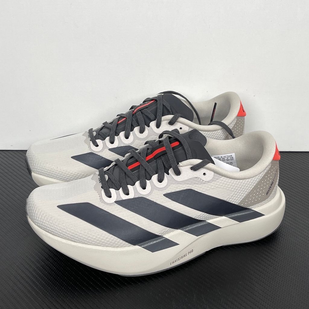 Side profile of the adidas Adizero Evo SL 'Audi F1' running shoe, highlighting the sleek motorsport-inspired aesthetic, ultra-lightweight breathable mesh upper, and the sculpted Lightstrike Pro foam midsole.