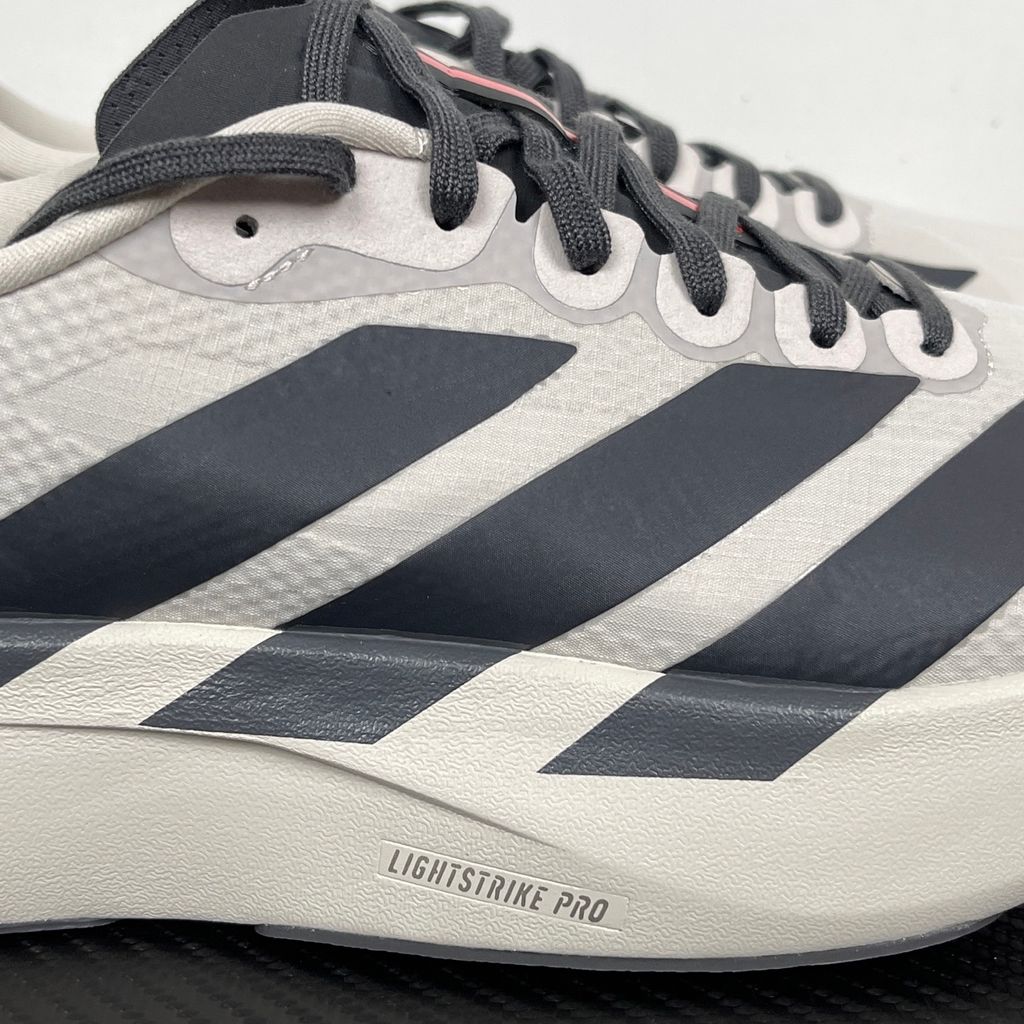 Side profile of the adidas Adizero Evo SL 'Audi F1' running shoe, highlighting the sleek motorsport-inspired aesthetic, ultra-lightweight breathable mesh upper, and the sculpted Lightstrike Pro foam midsole.