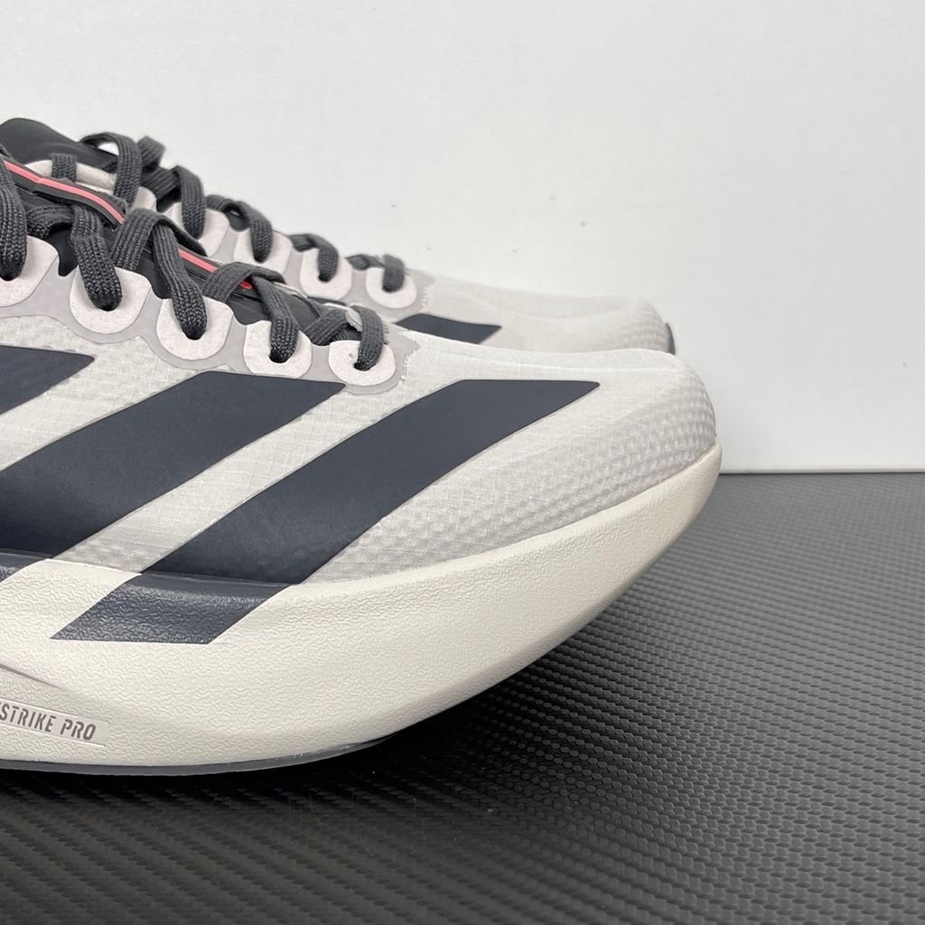 Side profile of the adidas Adizero Evo SL 'Audi F1' running shoe, highlighting the sleek motorsport-inspired aesthetic, ultra-lightweight breathable mesh upper, and the sculpted Lightstrike Pro foam midsole.