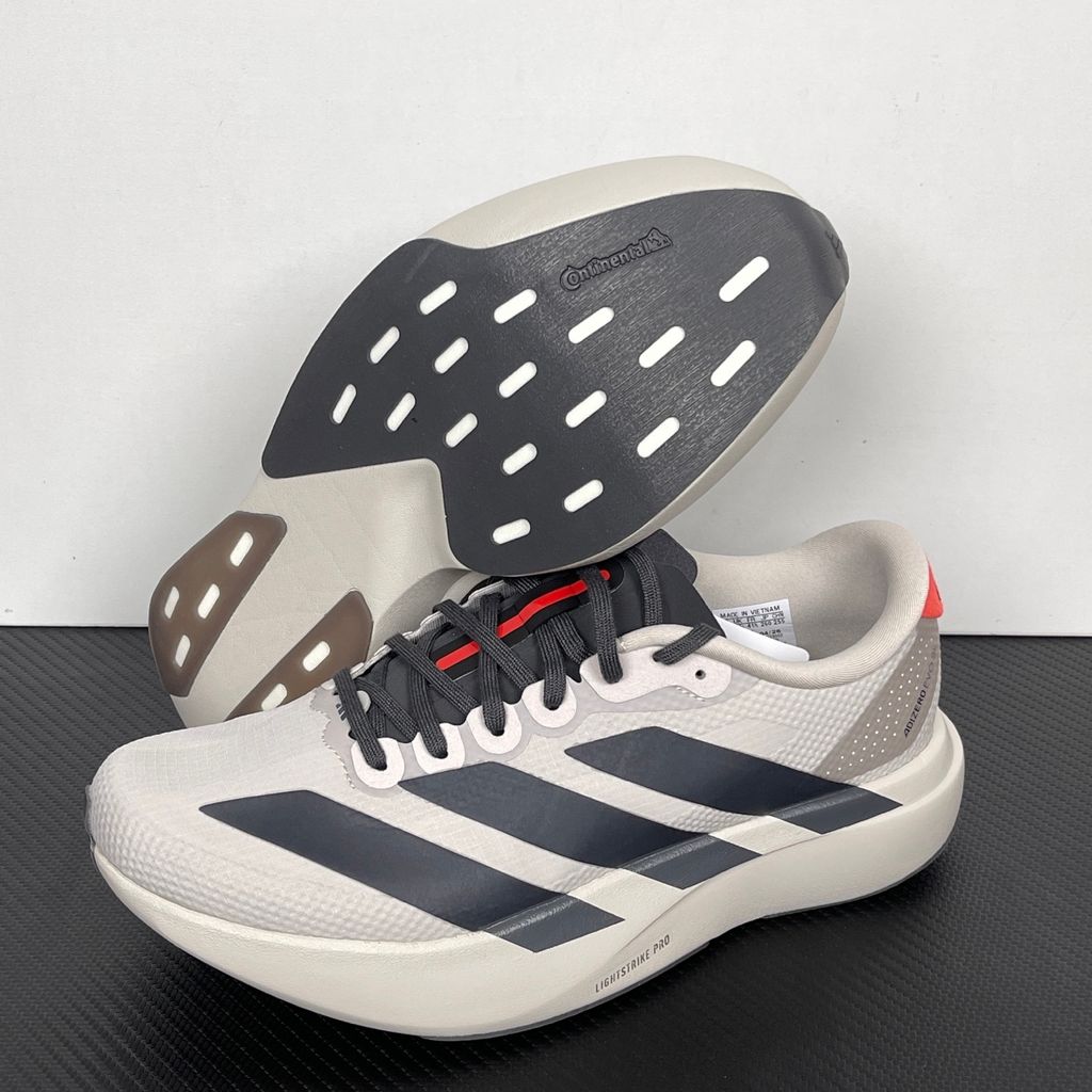 Side profile of the adidas Adizero Evo SL 'Audi F1' running shoe, highlighting the sleek motorsport-inspired aesthetic, ultra-lightweight breathable mesh upper, and the sculpted Lightstrike Pro foam midsole.