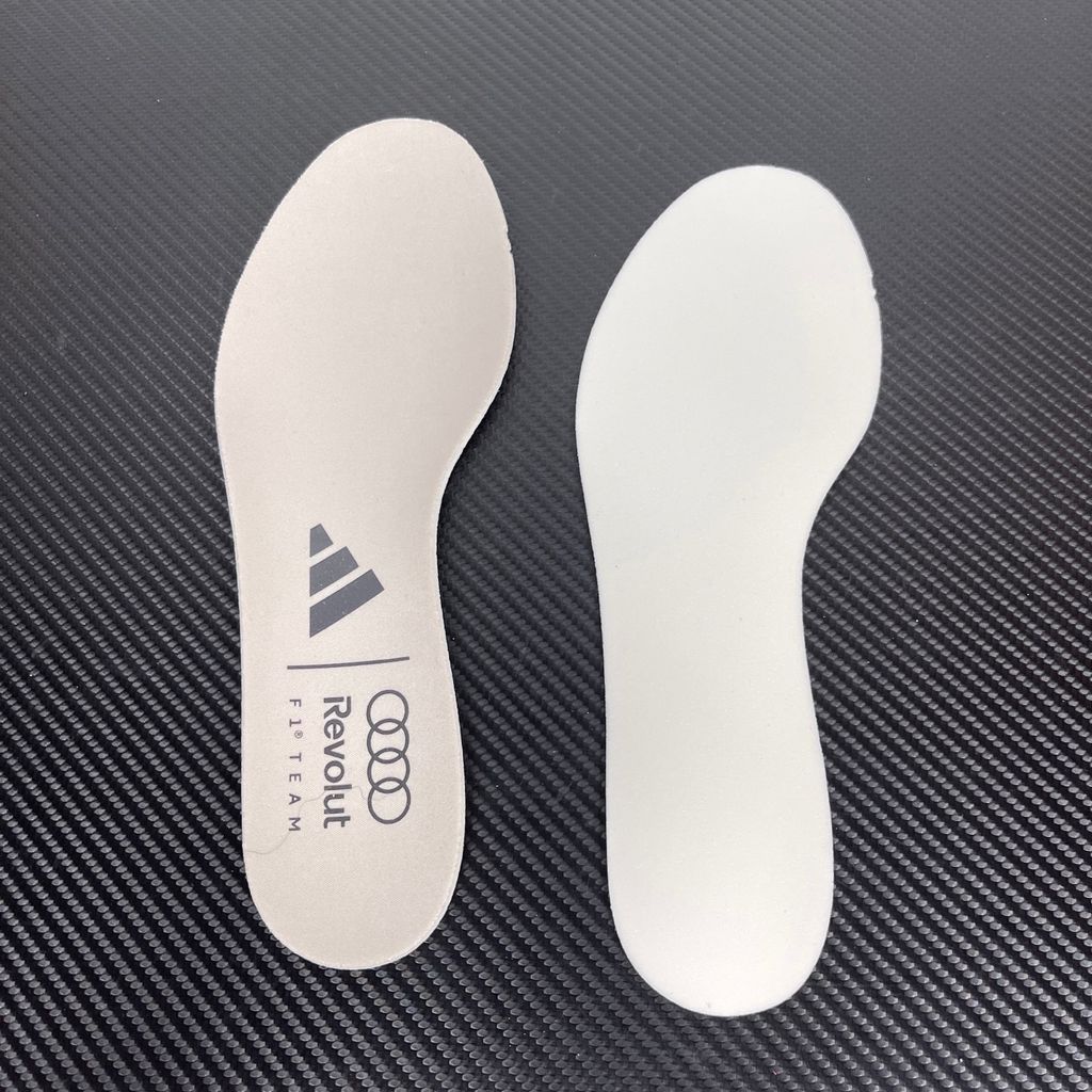 Side profile of the adidas Adizero Evo SL 'Audi F1' running shoe, highlighting the sleek motorsport-inspired aesthetic, ultra-lightweight breathable mesh upper, and the sculpted Lightstrike Pro foam midsole.