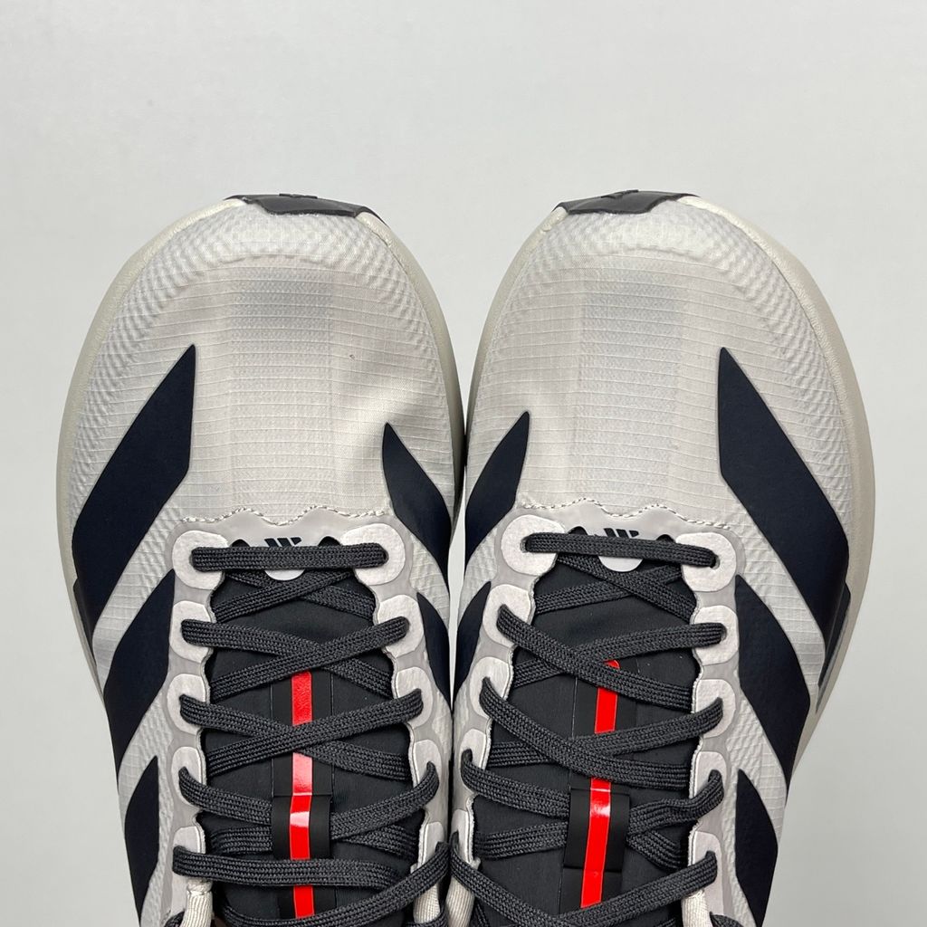 Side profile of the adidas Adizero Evo SL 'Audi F1' running shoe, highlighting the sleek motorsport-inspired aesthetic, ultra-lightweight breathable mesh upper, and the sculpted Lightstrike Pro foam midsole.