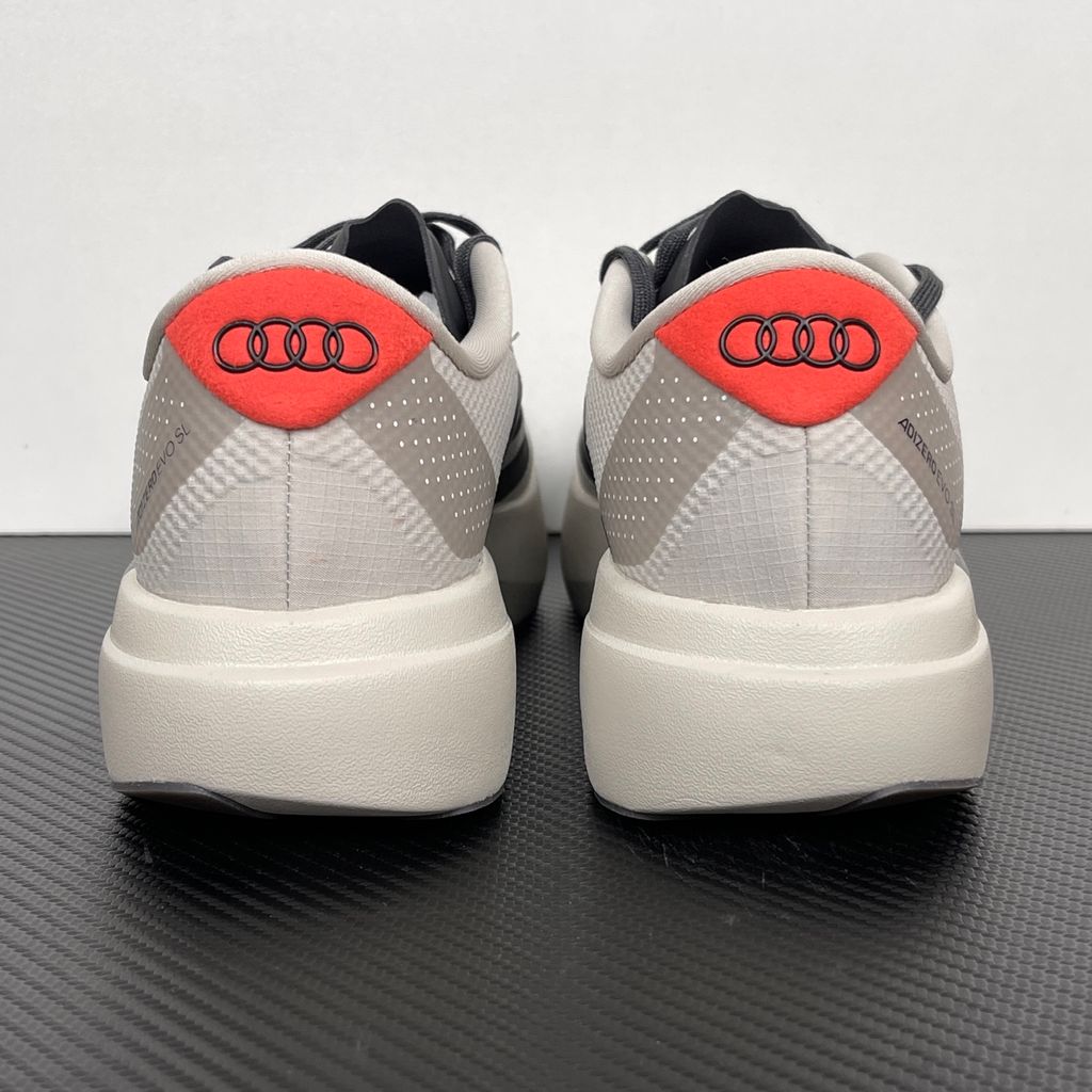 Side profile of the adidas Adizero Evo SL 'Audi F1' running shoe, highlighting the sleek motorsport-inspired aesthetic, ultra-lightweight breathable mesh upper, and the sculpted Lightstrike Pro foam midsole.