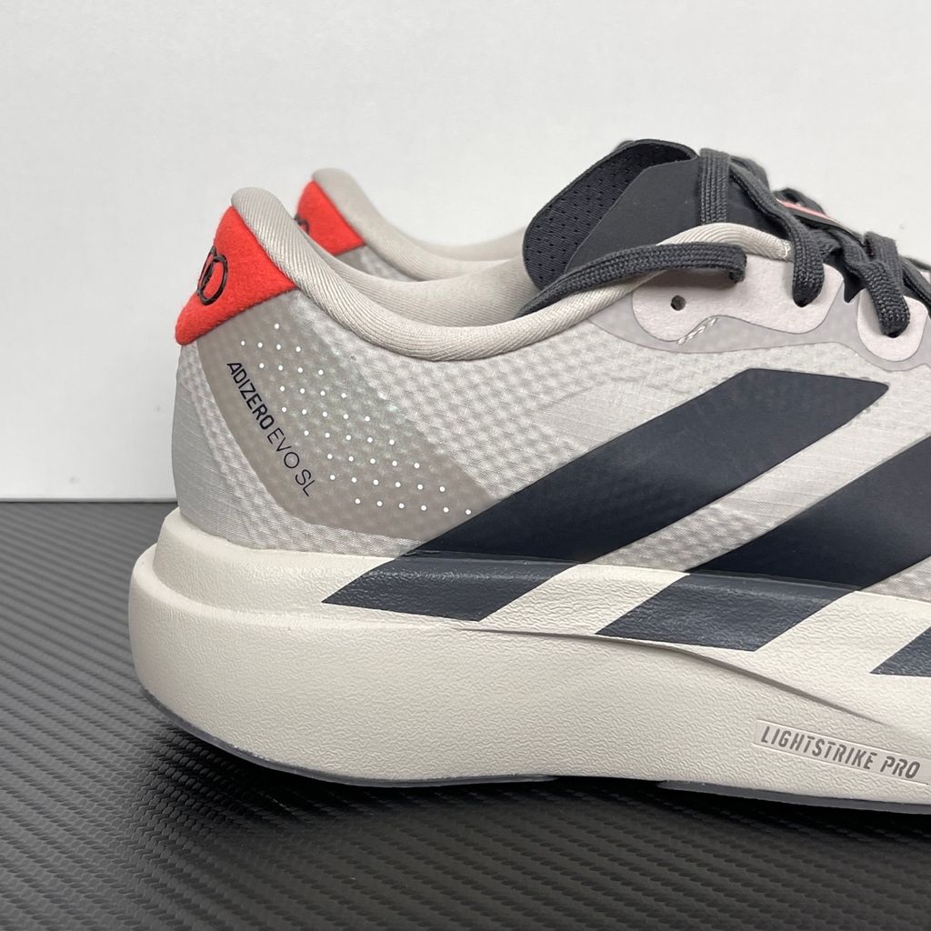 Side profile of the adidas Adizero Evo SL 'Audi F1' running shoe, highlighting the sleek motorsport-inspired aesthetic, ultra-lightweight breathable mesh upper, and the sculpted Lightstrike Pro foam midsole.