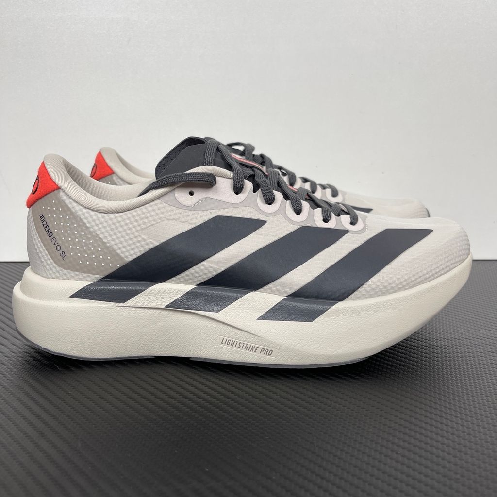 Side profile of the adidas Adizero Evo SL 'Audi F1' running shoe, highlighting the sleek motorsport-inspired aesthetic, ultra-lightweight breathable mesh upper, and the sculpted Lightstrike Pro foam midsole.