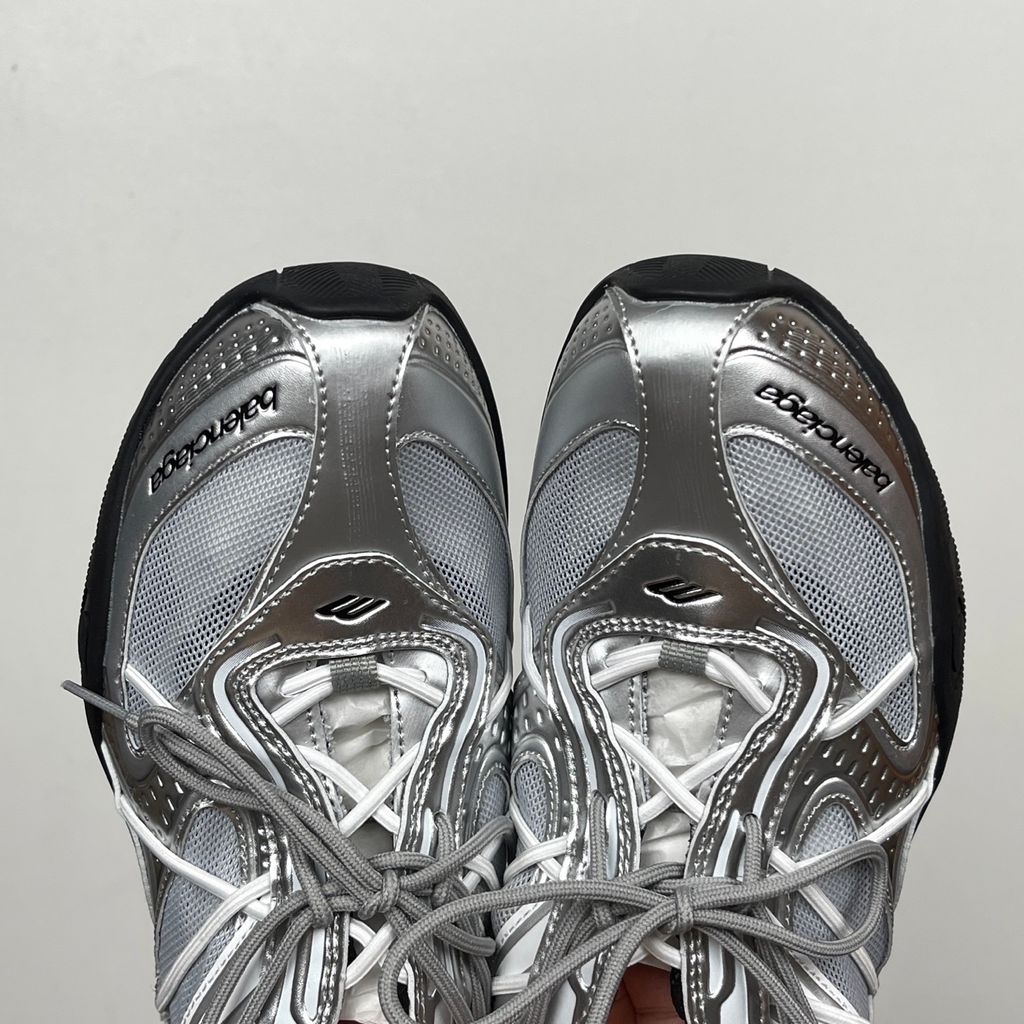 Side profile of the Balenciaga Radar Sneaker featuring a metallic silver and grey mesh upper, intricate gradient line overlays, a classic lace-up system, and a sleek, low-profile black rubber outsole.