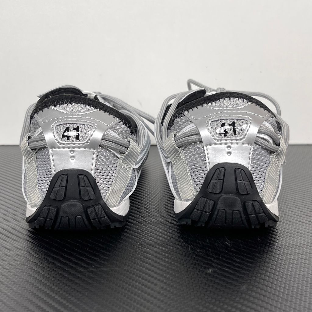 Side profile of the Balenciaga Radar Sneaker featuring a metallic silver and grey mesh upper, intricate gradient line overlays, a classic lace-up system, and a sleek, low-profile black rubber outsole.