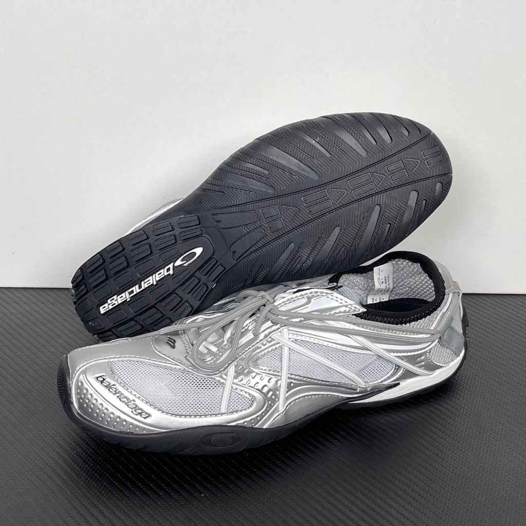 Side profile of the Balenciaga Radar Sneaker featuring a metallic silver and grey mesh upper, intricate gradient line overlays, a classic lace-up system, and a sleek, low-profile black rubber outsole.