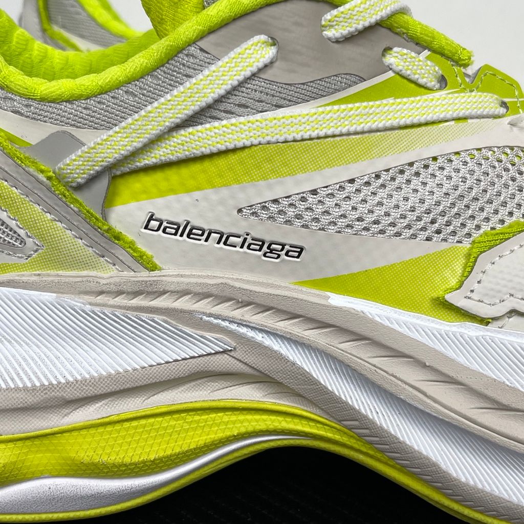 Side profile of the Balenciaga Jet Sneaker highlighting the eggshell white and vibrant light lime green upper, heavily distressed mesh detailing, embossed branding, and the signature 4.25cm exaggerated platform sole.