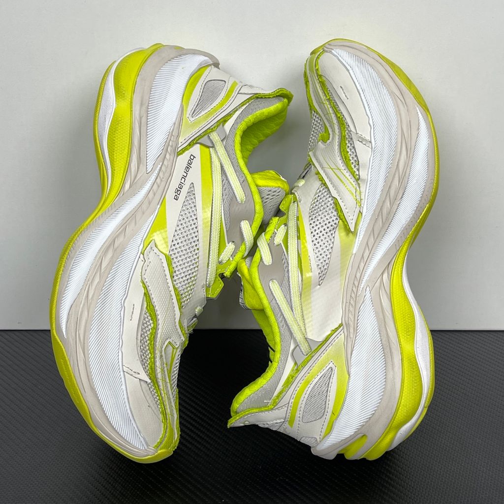 Side profile of the Balenciaga Jet Sneaker highlighting the eggshell white and vibrant light lime green upper, heavily distressed mesh detailing, embossed branding, and the signature 4.25cm exaggerated platform sole.
