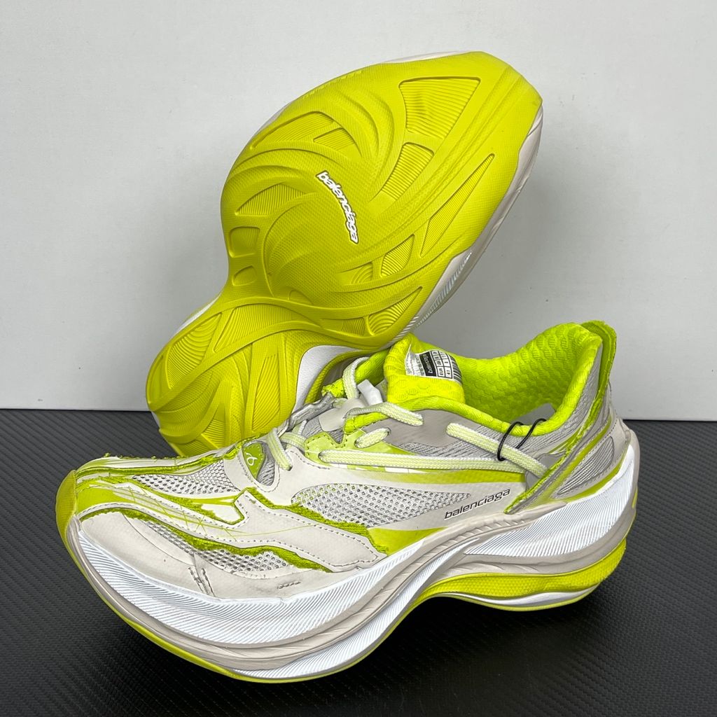 Side profile of the Balenciaga Jet Sneaker highlighting the eggshell white and vibrant light lime green upper, heavily distressed mesh detailing, embossed branding, and the signature 4.25cm exaggerated platform sole.