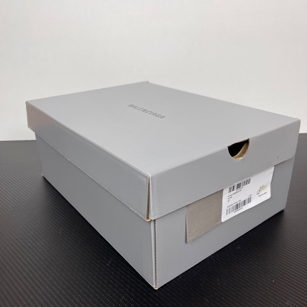 Side profile of the Balenciaga Jet Sneaker highlighting the eggshell white and vibrant light lime green upper, heavily distressed mesh detailing, embossed branding, and the signature 4.25cm exaggerated platform sole.