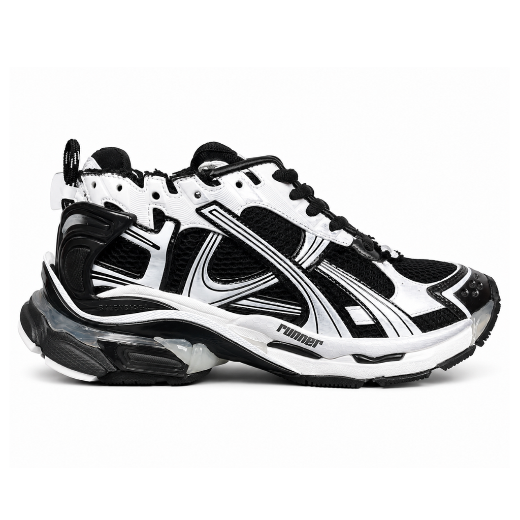 Side profile of the Balenciaga Runner LED sneaker in the 'Black/White' colorway, highlighting the intricate multi-layered mesh and synthetic construction, high-contrast paneling, and the clear heel capsule housing the LED technology.