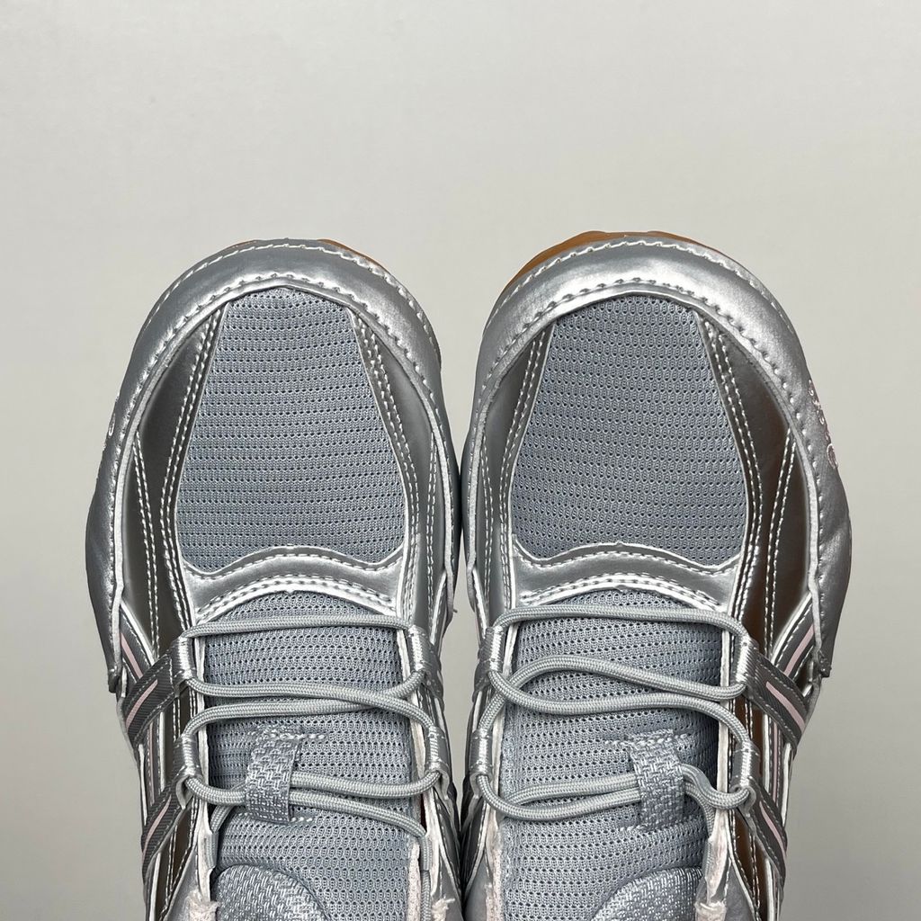 Side profile of the ASICS Hypersync sneaker in the Piedmont Grey and Pink Cloud colorway, showcasing the breathable technical mesh upper, metallic synthetic overlays, soft pink accents, and the sculpted performance midsole.