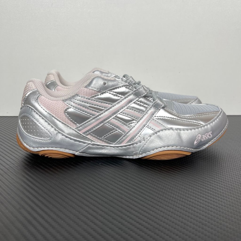 Side profile of the ASICS Hypersync sneaker in the Piedmont Grey and Pink Cloud colorway, showcasing the breathable technical mesh upper, metallic synthetic overlays, soft pink accents, and the sculpted performance midsole.
