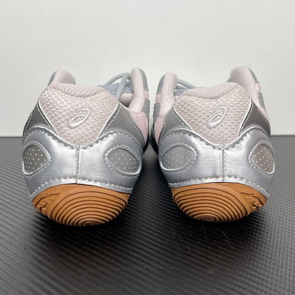 Side profile of the ASICS Hypersync sneaker in the Piedmont Grey and Pink Cloud colorway, showcasing the breathable technical mesh upper, metallic synthetic overlays, soft pink accents, and the sculpted performance midsole.