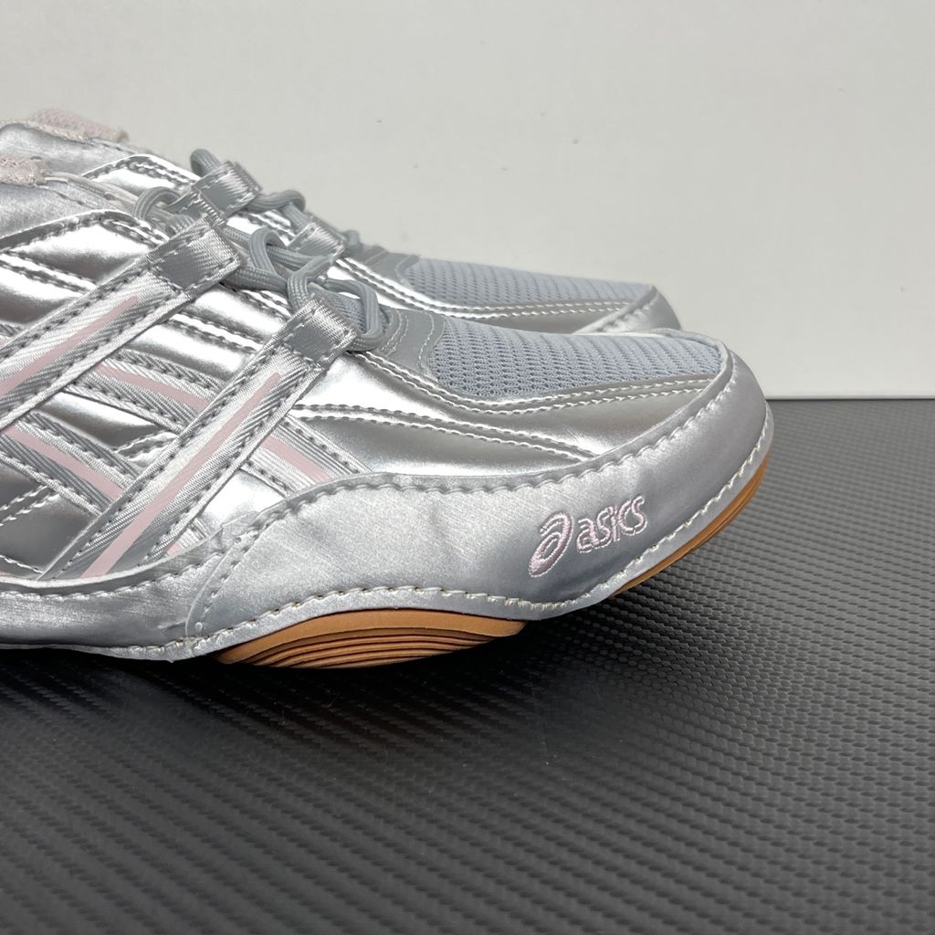 Side profile of the ASICS Hypersync sneaker in the Piedmont Grey and Pink Cloud colorway, showcasing the breathable technical mesh upper, metallic synthetic overlays, soft pink accents, and the sculpted performance midsole.