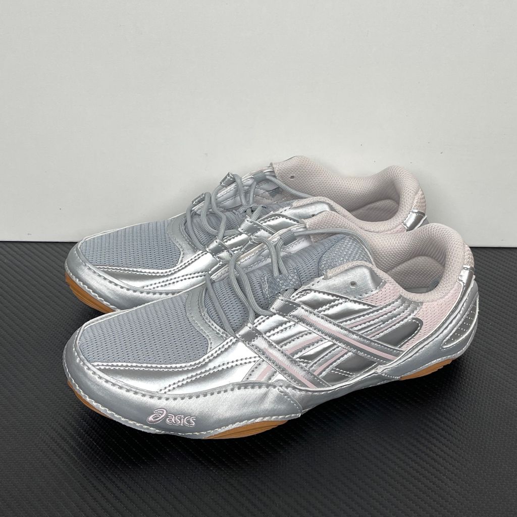 Side profile of the ASICS Hypersync sneaker in the Piedmont Grey and Pink Cloud colorway, showcasing the breathable technical mesh upper, metallic synthetic overlays, soft pink accents, and the sculpted performance midsole.