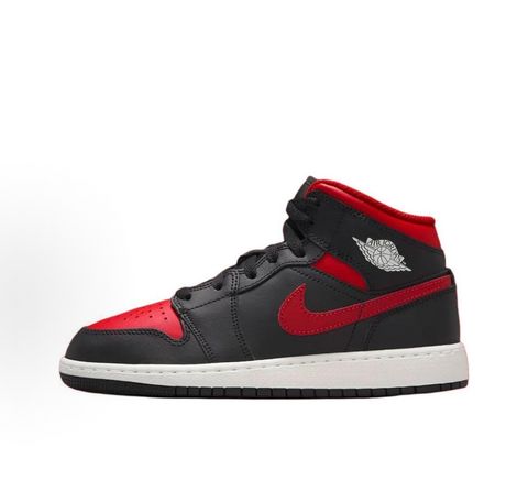 Side profile of the Air Jordan 1 Mid sneaker in the 'Bred Twist' colorway, featuring a crisp white leather base, bold black overlays, and vibrant University Red accents on the Swoosh, collar, and outsole.