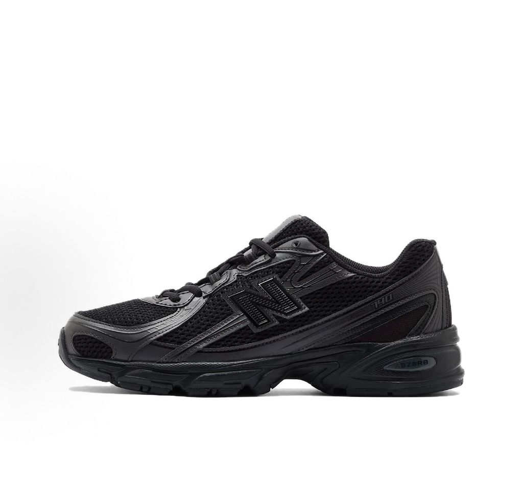 Side profile of the New Balance 740 sneaker in the 'Triple Black' colorway, showcasing the monochromatic mesh and synthetic upper, the tonal 'N' side logo, and the sculpted black midsole.